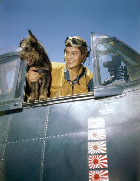 001a ARM3C Robert L. Brown inside an F6F Hellcat aboard USS Yorktown with 'Scrappy', the ship'...jpg