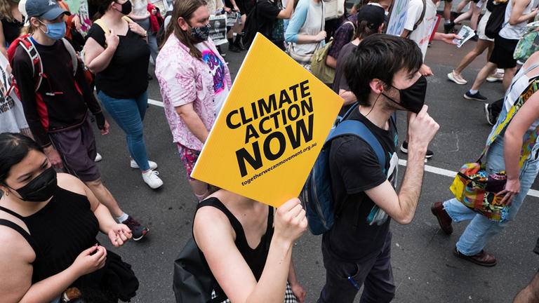 Climate change protestors are seen marching and changing as they carry placards on November 06, 2021, in Melbourne, Australia. Protests across Australia were organized as part of a global day of action demanding world leaders act decisively on climate to prevent catastrophic global warming. Photo by Asanka Ratnayake/Getty Images