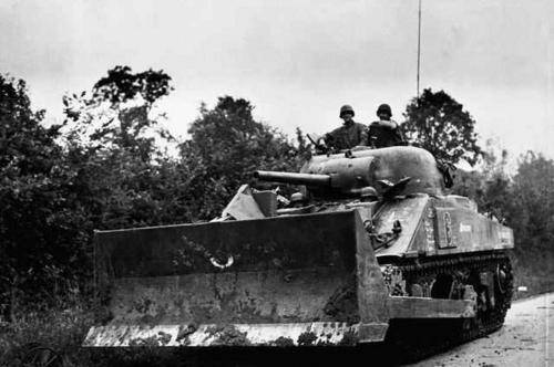 American-soldiers-drive-a-Sherman-tank-equipped-with-a-bulldozer-shovel_-France-August-7-1944.jpg