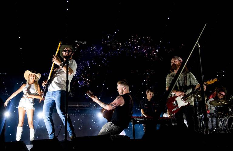 Hailey Welch, far left, joined Zach Bryan on stage as he performed at Nissan Stadium in Nashville, Tenn., Saturday, June 29, 2024.