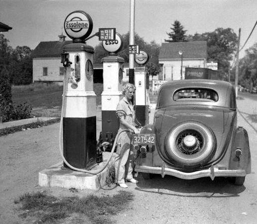 Service - A female Esso gas station attendant pumps 'Essolene' into a 1935 Ford in Danvers, Ma...jpg