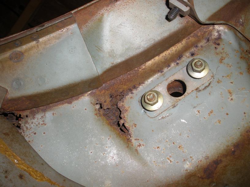 Underside of cowl below dash showing rust through and drivers windshield wiper mount bolts.JPG