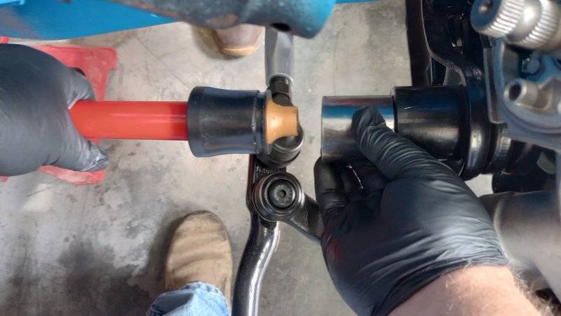 Using a socket to press the boot off the adapter onto the torsion bar (red).jpg